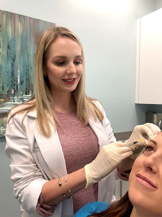 Brandie injecting a patient with filler