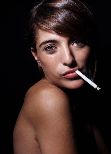brunette woman with cigarette in her mouth