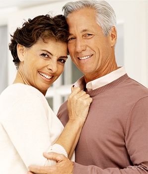 Mature couple holding each other and smiling 