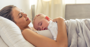 A woman relaxes with her baby after recently giving birth.