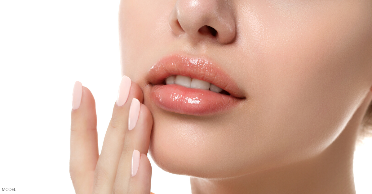 A woman with plump lips from dermal fillers.