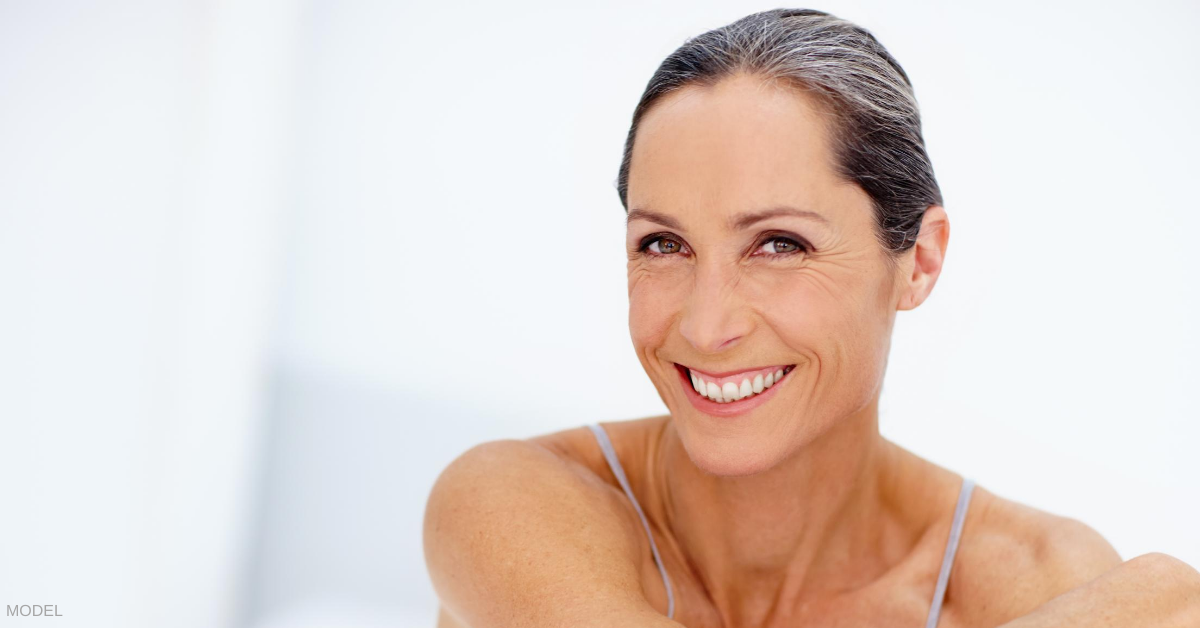 A middle aged woman pleased with her ponytail facelift.