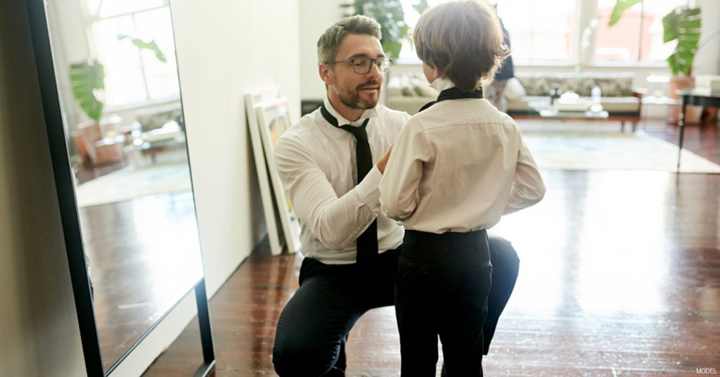 Slim Father Fixing His Son's Tie