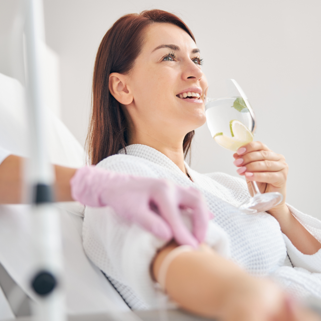 Women getting HYDRAhealth™ IV Therapy smiling (model)