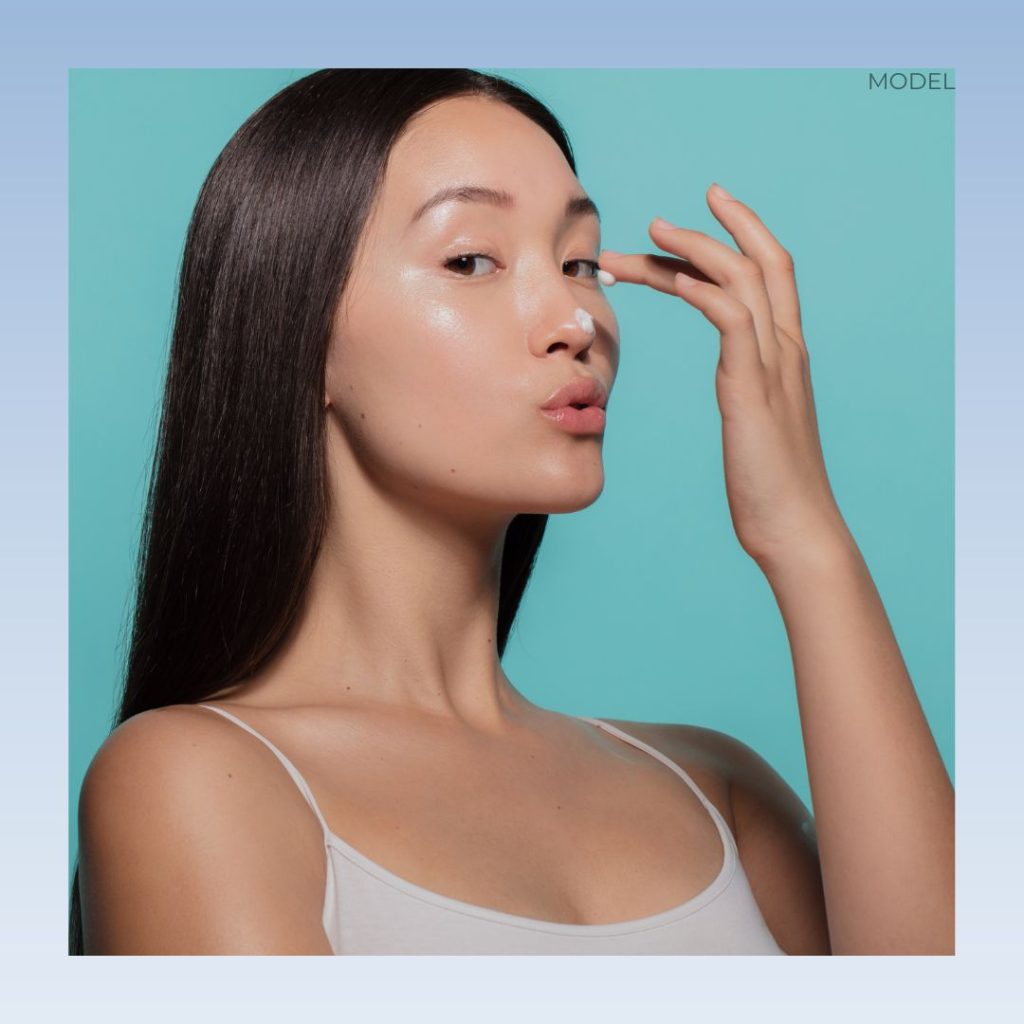 A woman putting on her skincare (model)
