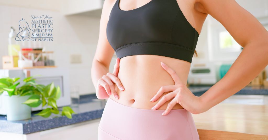 Woman with a fit stomach with her hands on her waist (model)