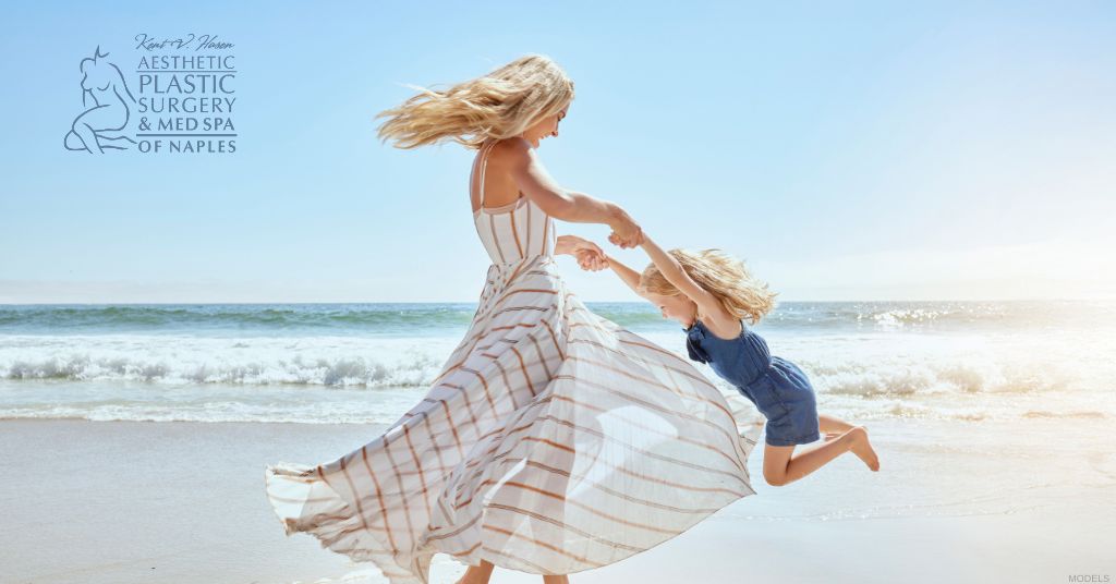 Woman with her daughter at the beach after a mommy makeover (models)